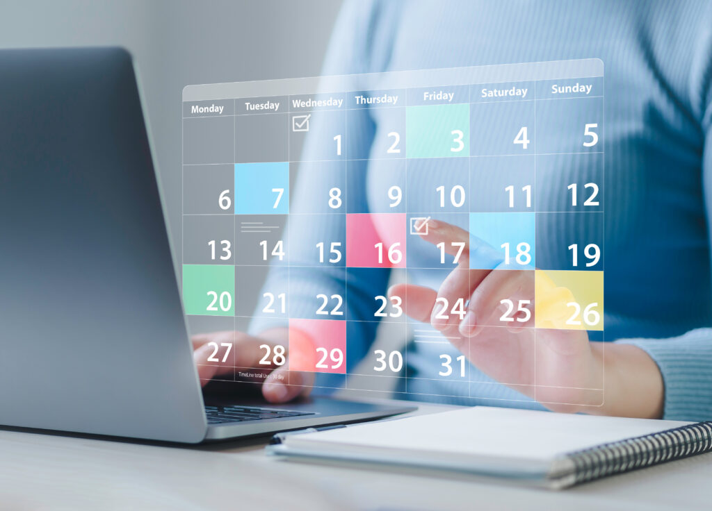 A professional using a digital calendar to maintain B2B social media consistency and scheduling.