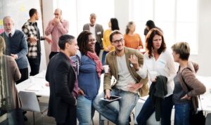 A diverse group of professionals networking and talking during a B2B business event.